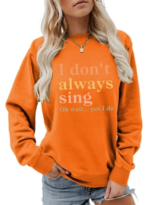 Detail of rib-knit cuffs and gradient text print on vibrant orange crewneck sweatshirt