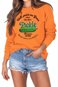 Detail of ribbed cuffs and humorous pickle print on orange casual long sleeve sweatshirt