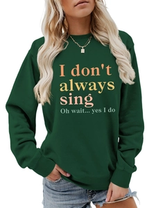 Detail of dark green sweatshirt featuring orange letter print and ribbed crewneck design