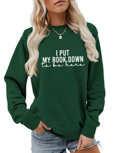Detail of white text print on deep green crewneck sweatshirt with high-quality fabric