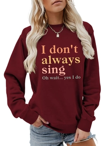 Detail of burgundy sweatshirt showing ribbed cuffs and music slogan print texture