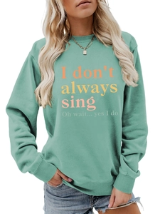 Detail of mint green sweatshirt featuring artistic singing slogan with ribbed cuffs