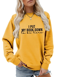 Detail of yellow sweatshirt showing I PUT MY BOOK DOWN print and ribbed cuffs