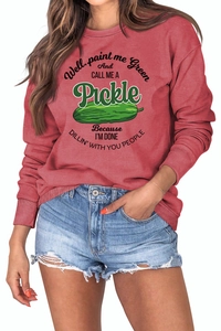 Macro detail of ribbed cuffs and pickles print on a brick red crewneck sweatshirt