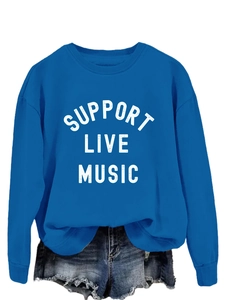 Close-up of blue crewneck sweatshirt with Support Live Music print and denim shorts