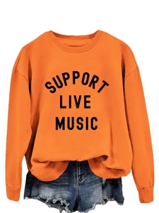 Close-up of Support Live Music slogan print on bright orange crewneck sweatshirt fabric