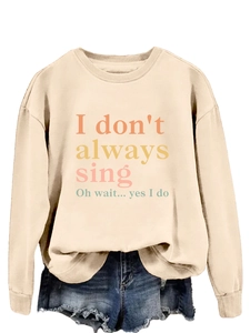 Detail of soft beige long sleeve sweatshirt with colorful I don't always sing typography