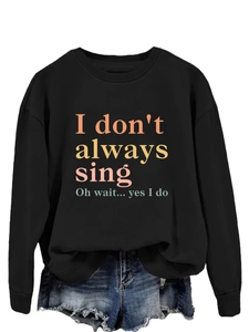 Close-up of black long sleeve sweatshirt featuring colorful I don't always sing print