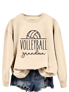 Detail of beige sweatshirt featuring Volleyball Grandma print and soft cotton texture