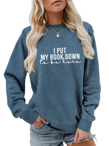 Detail of navy blue sweatshirt featuring white text print and ribbed crew neck finish