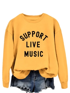 Detail of ribbed neckline and Support Live Music print on ginger yellow sweatshirt