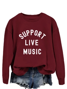 Detail view of Support Live Music white lettering on a burgundy crewneck sweatshirt