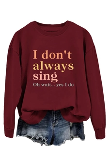 Macro detail of the crew neck collar on a burgundy long sleeve sweatshirt with print