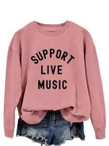 Detail of pink crewneck sweatshirt with Support Live Music print and ribbed cuffs