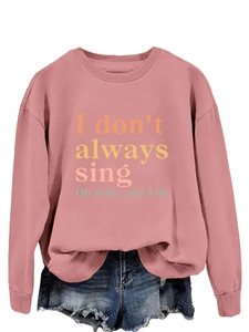 Flat lay of dusty rose sweatshirt with funny singing quote and frayed denim shorts