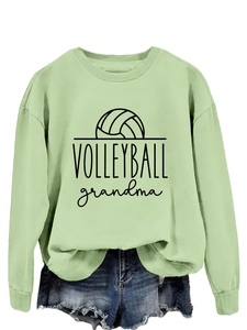Detail view of light green volleyball grandma sweatshirt and frayed denim shorts