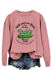 Pink oversized sweatshirt featuring humorous green pickle graphic and denim shorts detail