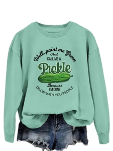 Close-up of light green sweatshirt featuring a pickle graphic and soft knitted texture