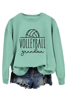 Detail of mint green sweatshirt with Volleyball Grandma print and blue denim shorts
