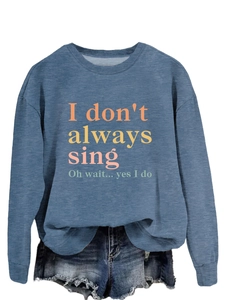 Detail of ribbed cuffs and crewneck on mid-blue long sleeve sweatshirt with print