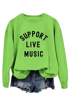 Flat lay of neon green sweatshirt featuring black Support Live Music print design