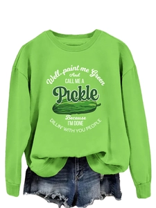 Detail of green pickle sweatshirt fabric and slogan print on loose fit cotton top