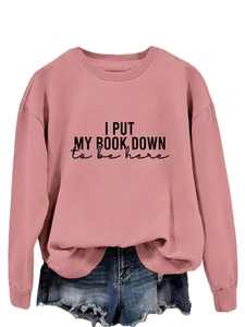Close-up of pink long sleeve sweatshirt with black letter print and ribbed collar detail
