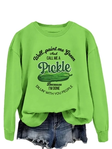 Detail of loose fit neon green sweatshirt featuring pickle graphic and humorous slogan