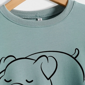 Women's crewneck sweatshirt in sage green featuring a minimalist pig line art print