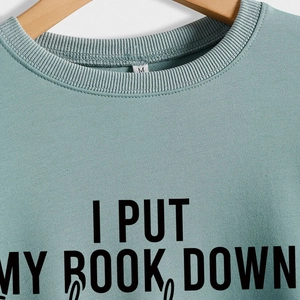 Sage green crewneck sweatshirt featuring I PUT MY BOOK DOWN black letter print on chest