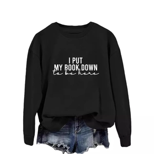 Black long sleeve sweatshirt with white letter print and denim shorts on white background