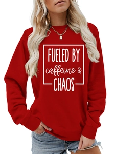 Detail of red crewneck sweatshirt featuring white FUELED BY caffeine & CHAOS letter print