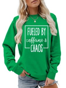 Detail of emerald green crewneck sweatshirt with Fueled by Caffeine and Chaos print