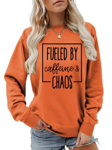 Detail of Fueled by Caffeine and Chaos print on orange crewneck sweatshirt