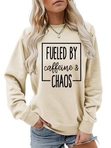 Close-up of Fueled by Caffeine and Chaos print on a beige crewneck sweatshirt
