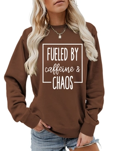 Detail of dark brown crewneck sweatshirt featuring white caffeine & chaos slogan print