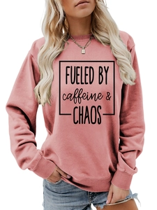 Detail of dusty pink crewneck sweatshirt with Fueled by Caffeine and Chaos print