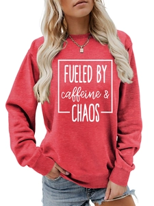 Detail of red crewneck sweatshirt featuring white text print with ribbed cuffs and hem