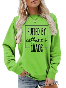 Detail of Fueled by Caffeine and Chaos print on green crewneck sweatshirt