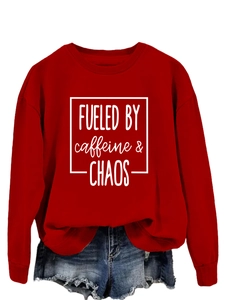 Detail of red crewneck sweatshirt with Fueled by Caffeine and Chaos print and ribbed cuffs