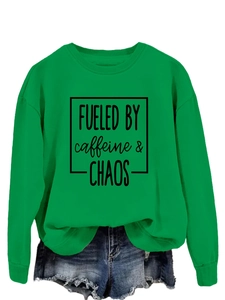 Detail of green crewneck sweatshirt with black caffeine and chaos print and denim shorts