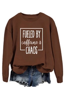 Flat lay of brown long sleeve sweatshirt with Fueled by Caffeine text and denim shorts