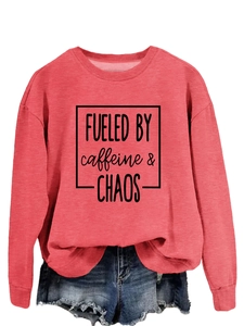 Detail of Fueled by Caffeine and Chaos print on pink crewneck sweatshirt