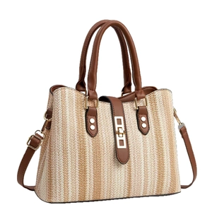 Striped straw tote bag with brown leather handles and adjustable shoulder strap