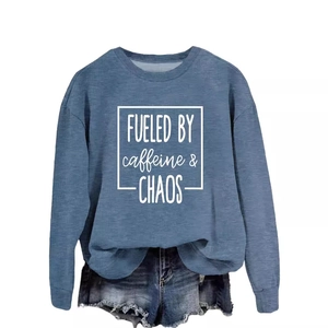 Fueled by Caffeine Chaos grey-blue sweatshirt paired with denim shorts on white background