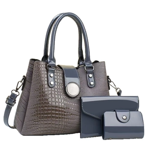 Three-piece women's handbag set in grey-blue faux crocodile leather with metal buckle