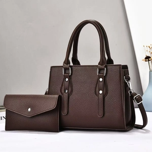 Close-up of deep brown lychee texture leather tote bag set with silver rivets and handles