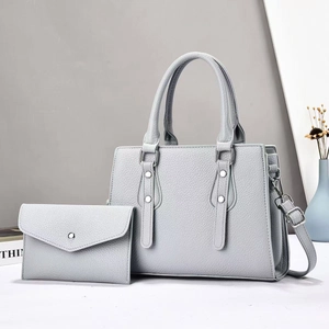 Light gray litchi pattern leather tote bag set with matching envelope wallet and silver hardware