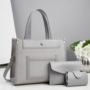 Three-piece set of gray textured tote bag, crossbody clutch, and round coin purse for women