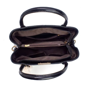 Interior view of black shiny handbag featuring multiple zipper pockets and large capacity
